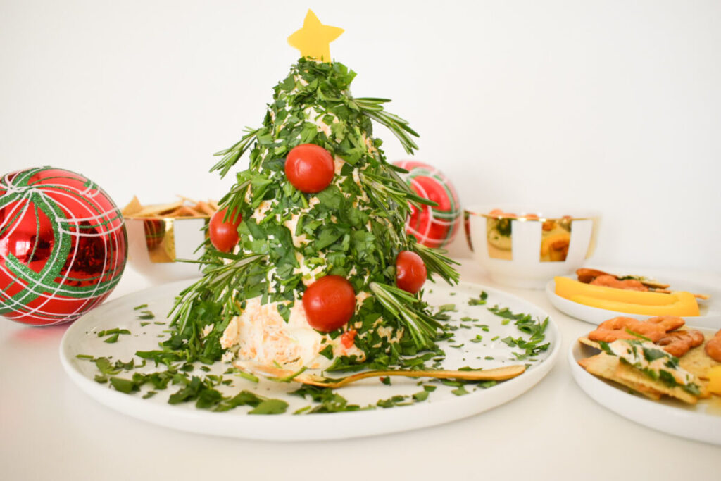 cheese ball made into the shape of a Christmas tree