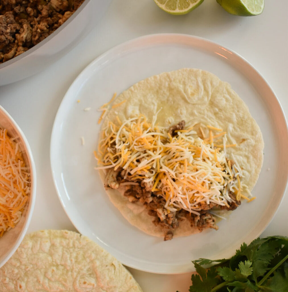 Assembling beef and turkey tacos for baked taco recipe