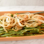 Roasted green beans topped with caramelized onions