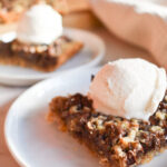 Chocolate chip pecan bars topped with vanilla ice cream