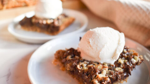 Chocolate chip pecan bars topped with vanilla ice cream