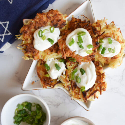 Potato latkes topped with greek yogurt and green onion