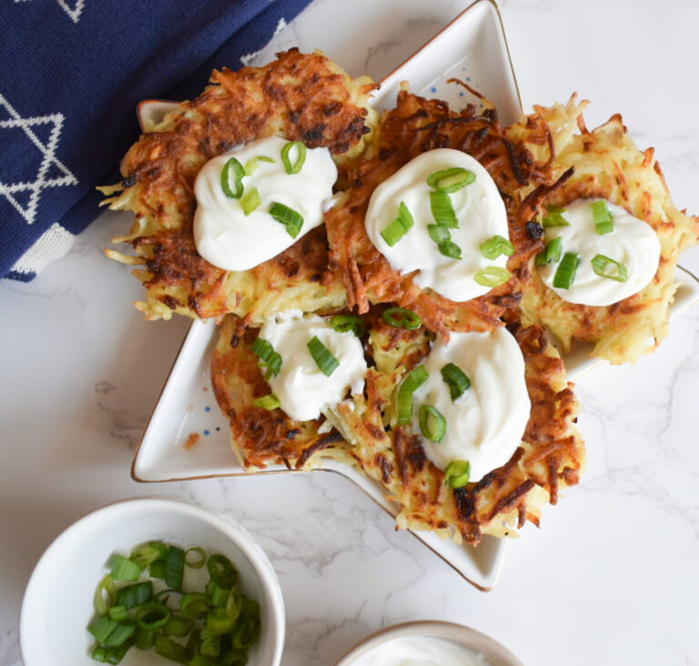 Potato latkes topped with greek yogurt and green onion