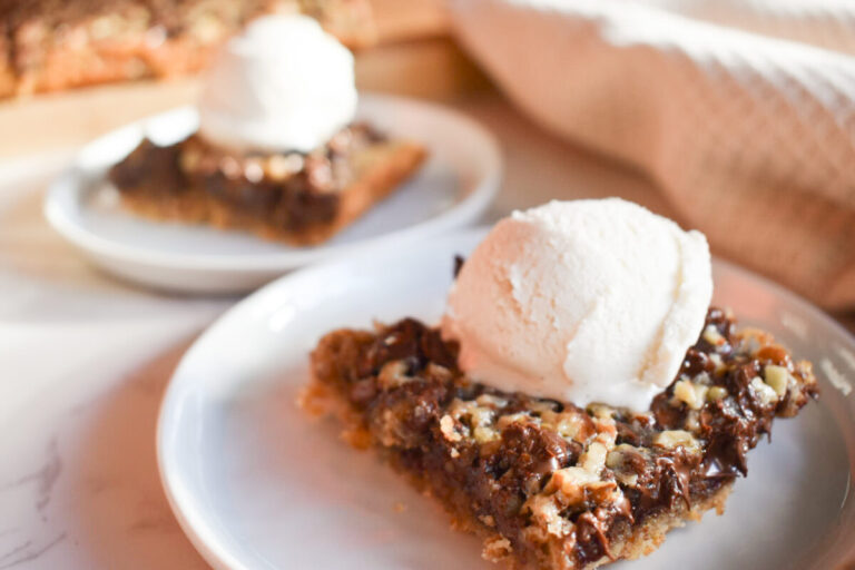 Chocolate chip pecan bars topped with vanilla ice cream