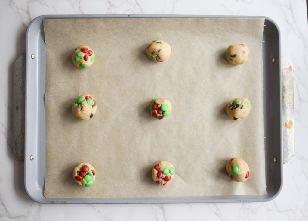 Holiday cookies on a baking sheet ready to be baked. 