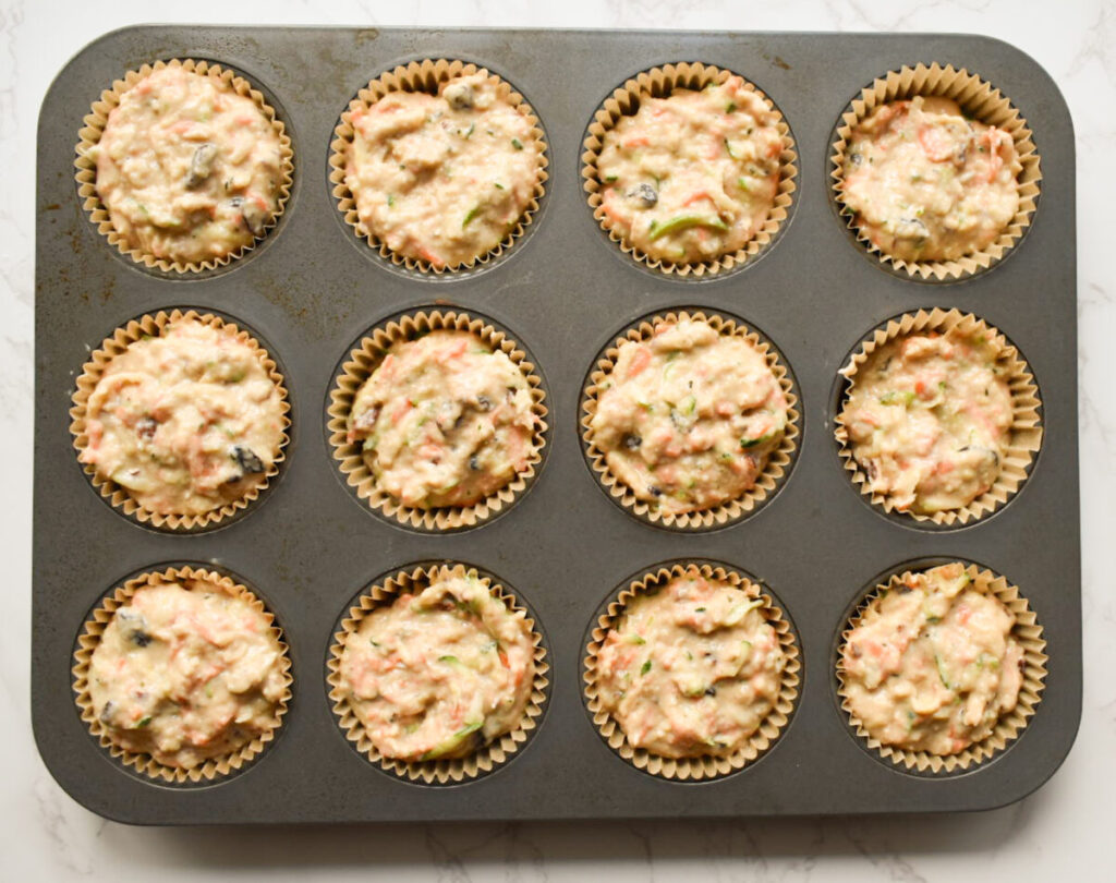 muffin batter in prepared muffin tin