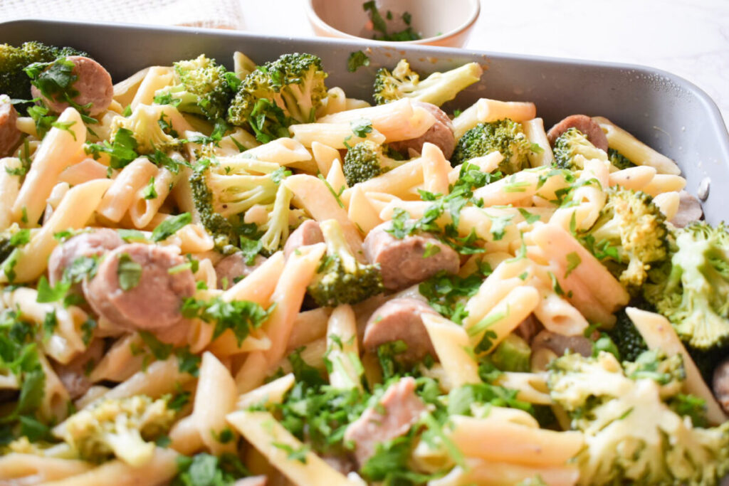 baked penne pasta with broccoli, alfredo sauce, and chicken sausage