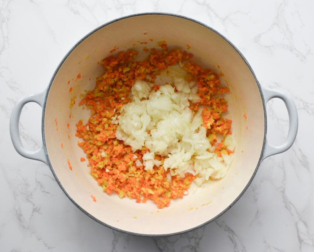 add onion and garlic to saute carrots and celery in butter for broccoli cheddar soup