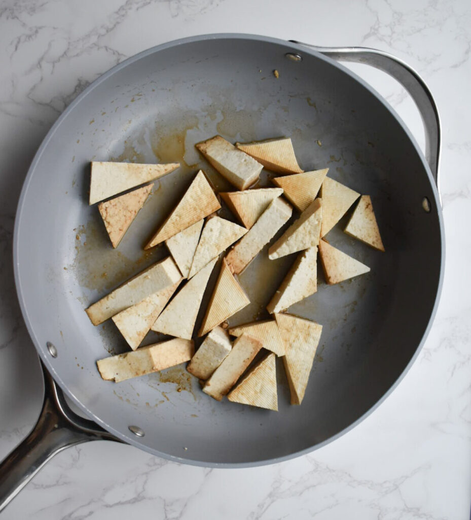 cooking tofu in skillet until golden brown and slightly crisp