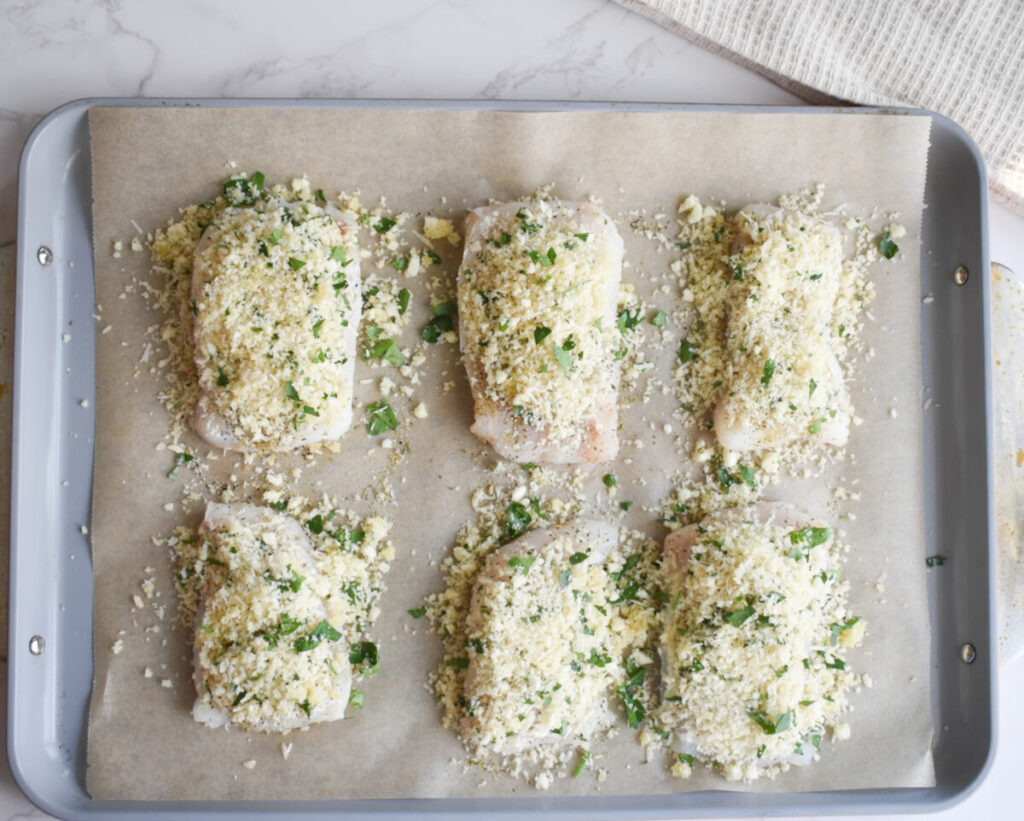 cod fillets topped with panko and parmesan, ready to be baked