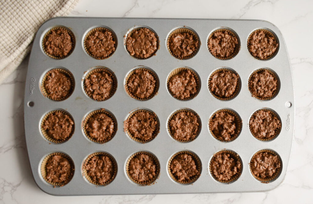 chocolatey peanut butter crispy treat in mini muffin tin