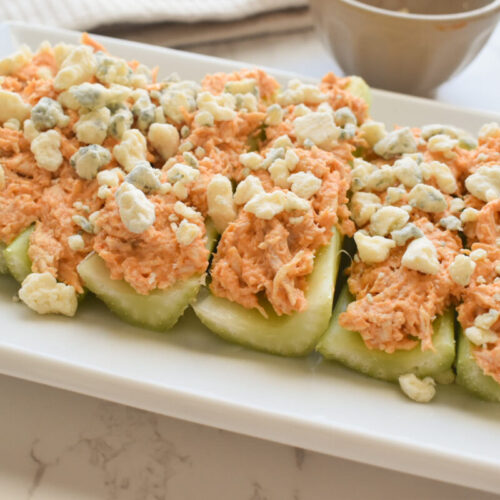 buffalo chicken mixture over celery sticks, topped with blue cheese