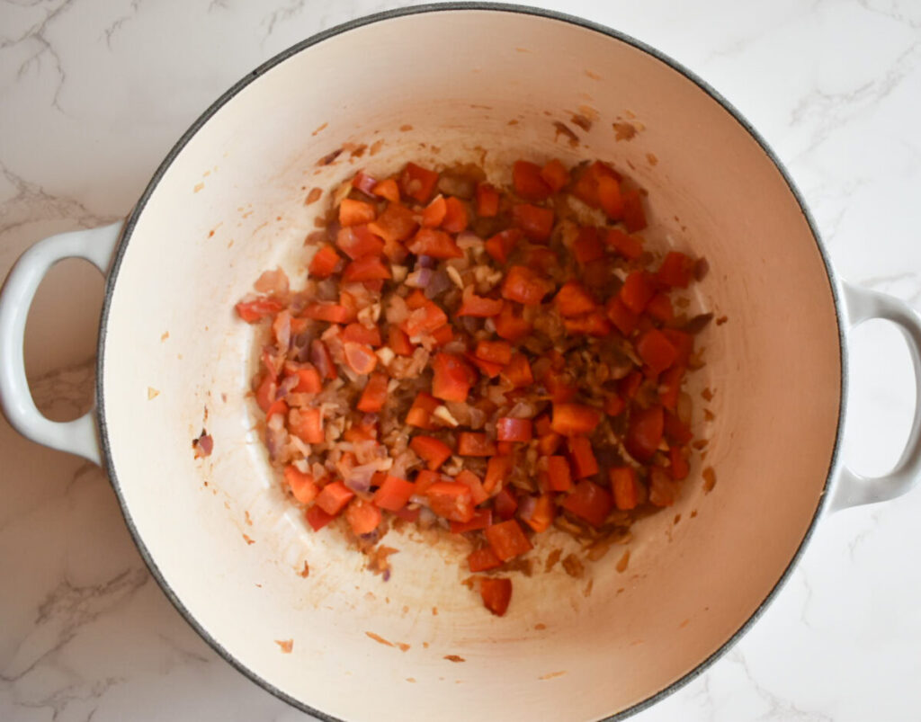 red bell pepper being sautéed for turkey chili