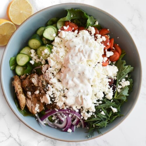 green salad with tzatziki for dressing and baked chicken thighs