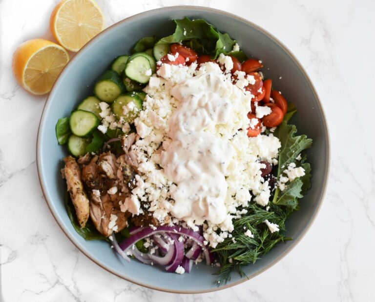 green salad with tzatziki for dressing and baked chicken thighs