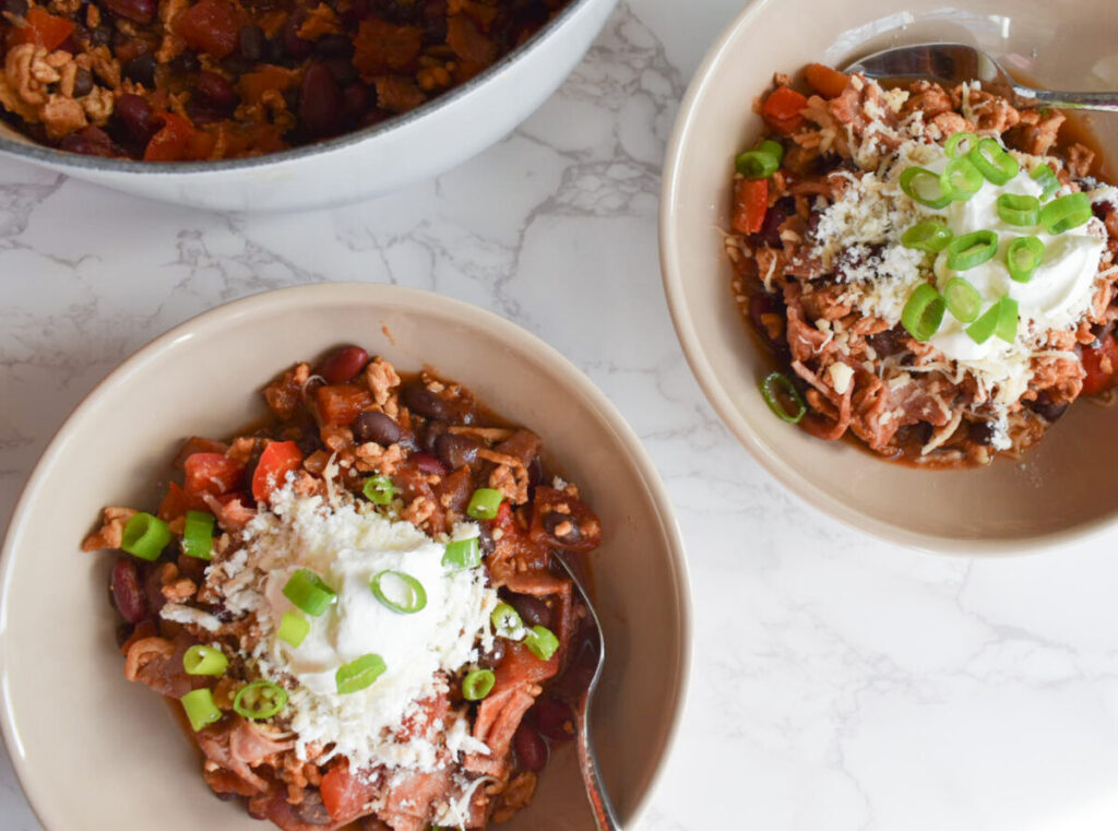 turkey chili made with turkey bacon and topped with sour cream and chives