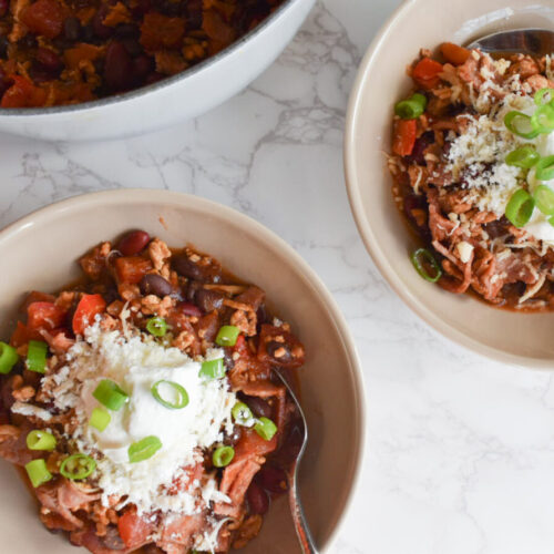 turkey chili made with turkey bacon and topped with sour cream and chives