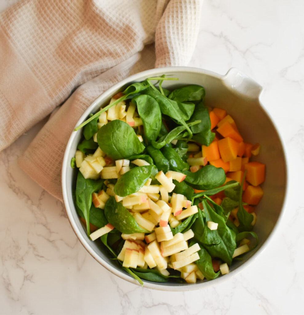 mixture of spinach, butternut squash, and apple for sheet pan meal