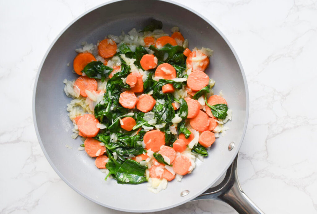 cooked spinach and carrots for homemade chicken pot pie