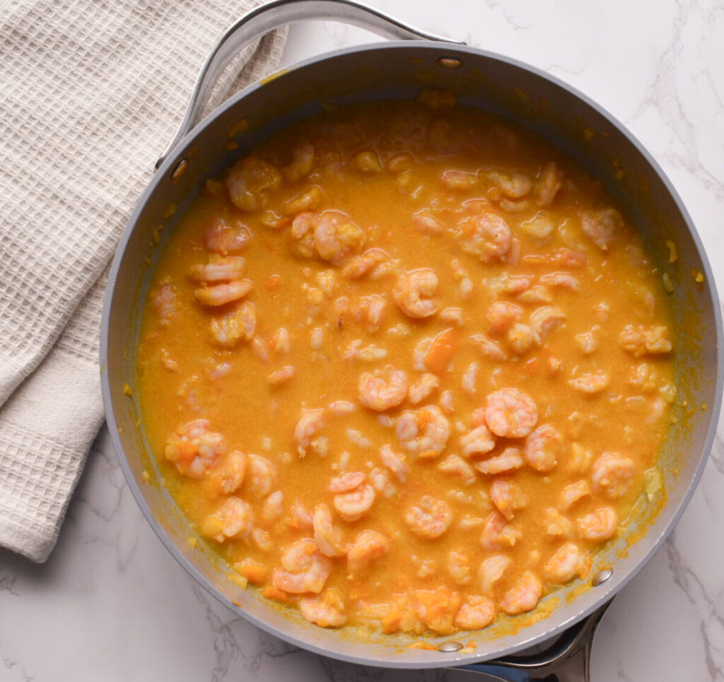 shrimp cooking in a coconut milk sauce